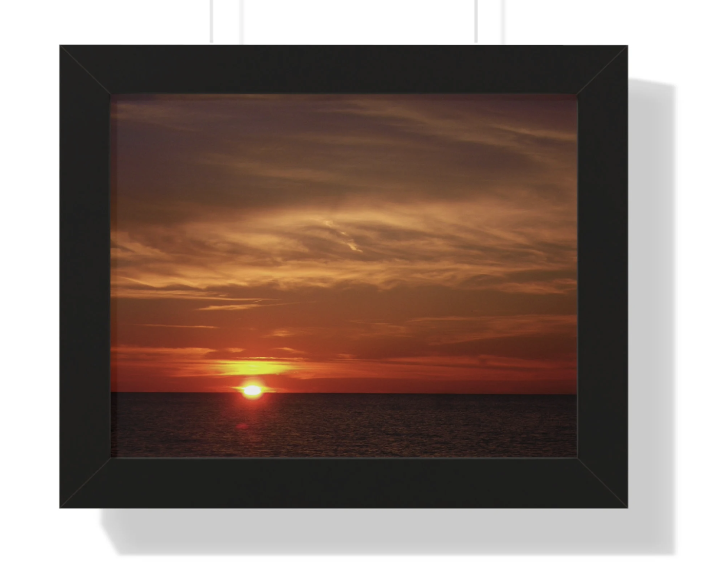 sunset over lake eire during the fall black frame hanging on a wall